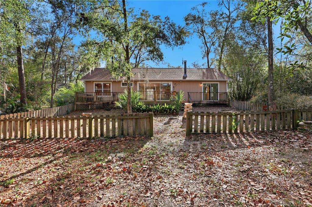 8006 Southwest 62 Lane Gainesville, FL 32608 - Photo 2 of 17 a front view of a house with a garden
