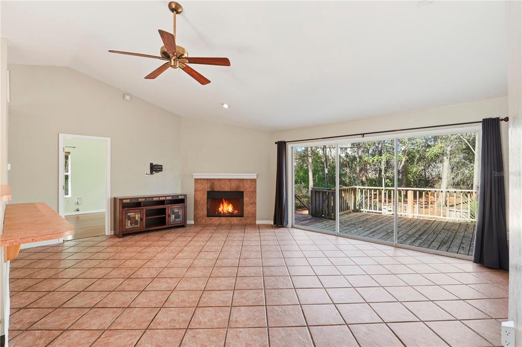 8006 Southwest 62 Lane Gainesville, FL 32608 - Photo 4 of 17 a view of an empty room with a fireplace and a large window