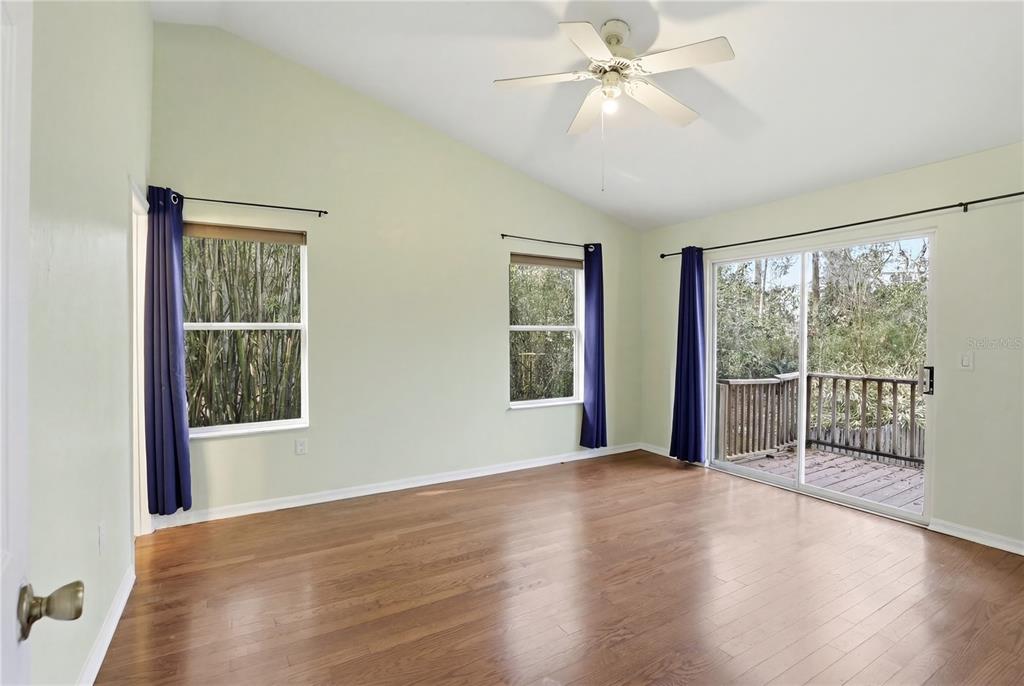 8006 Southwest 62 Lane Gainesville, FL 32608 - Photo 7 of 17 a view of an empty room with wooden floor and a window