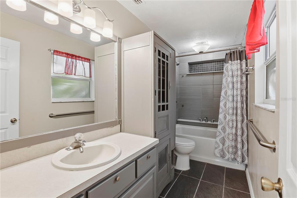8006 Southwest 62 Lane Gainesville, FL 32608 - Photo 9 of 17 a bathroom with a sink toilet and shower