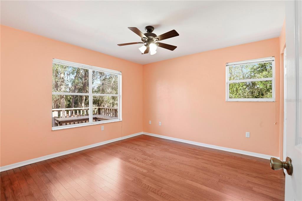 8006 Southwest 62 Lane Gainesville, FL 32608 - Photo 10 of 17 a view of an empty room with wooden floor and a window