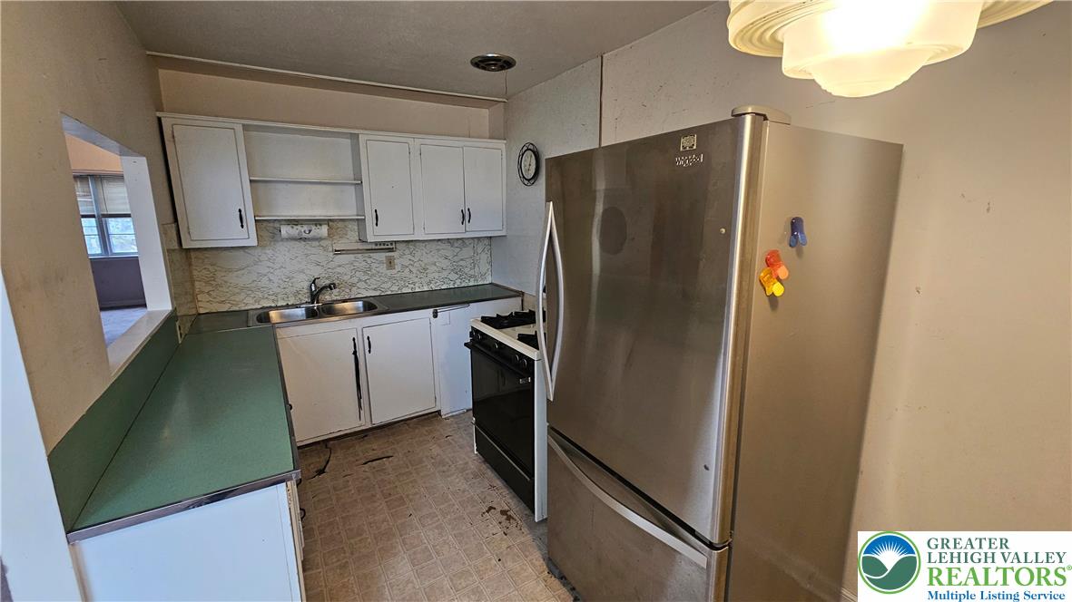 2335 4th Street Wilson, PA 18042 - Photo 14 of 48 a kitchen with stainless steel appliances granite countertop a refrigerator and a sink