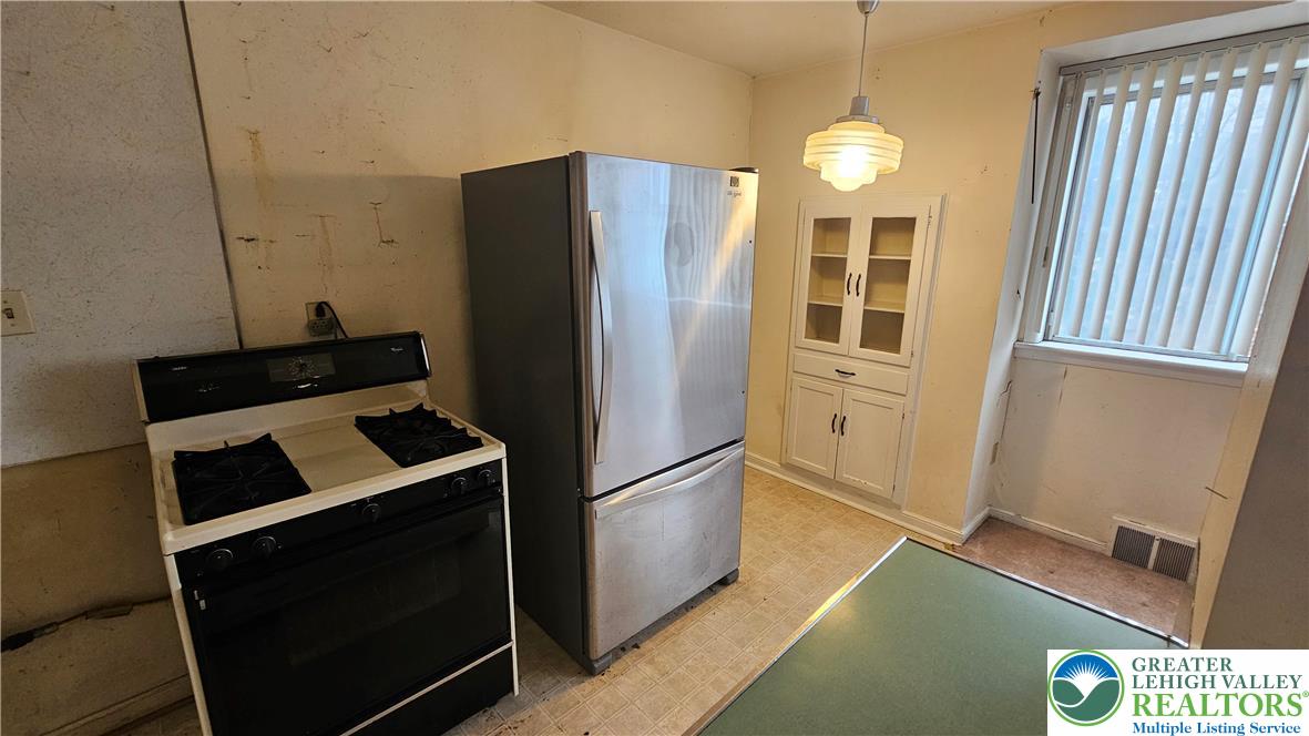 2335 4th Street Wilson, PA 18042 - Photo 17 of 48 a kitchen with a refrigerator and a stove top oven