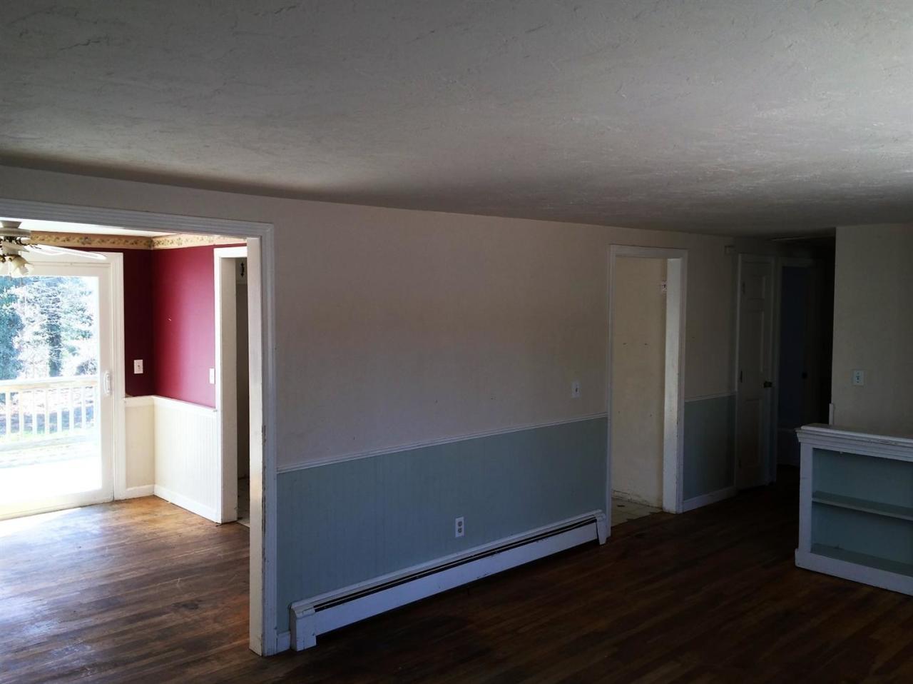 6 Crooked Pond Road Hyannis, MA 02601 - Photo 3 of 10 an empty room with wooden floor and windows