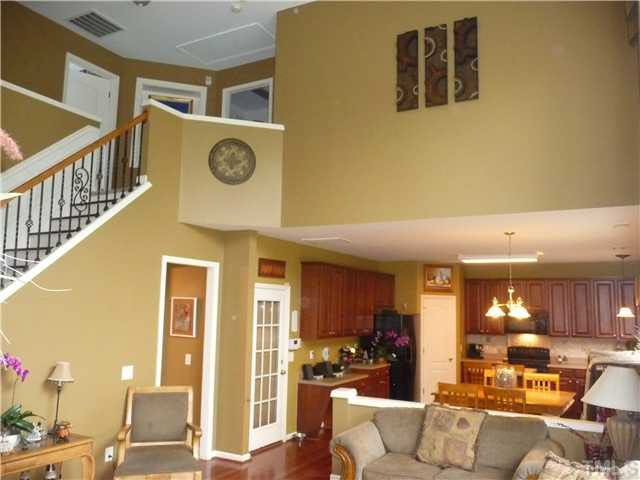 7624 Silver View Lane Raleigh, NC 27613 - Photo 12 of 25 a living room with couches and kitchen view