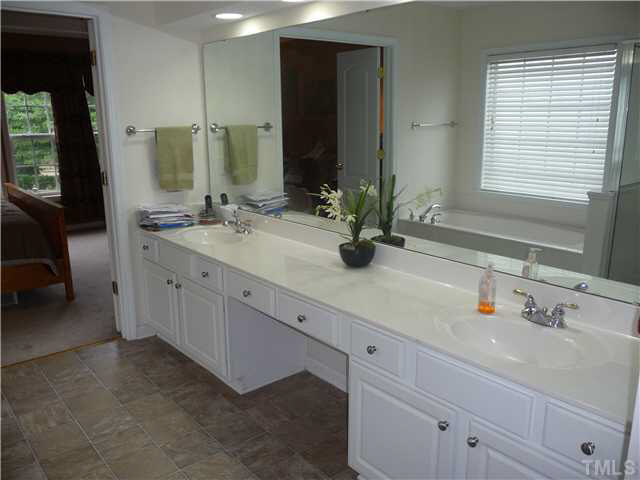 7624 Silver View Lane Raleigh, NC 27613 - Photo 16 of 25 a bathroom with double sink and a mirror