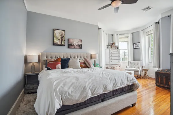a bedroom with a bed and glass window