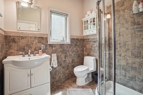a bathroom with a sink toilet and shower
