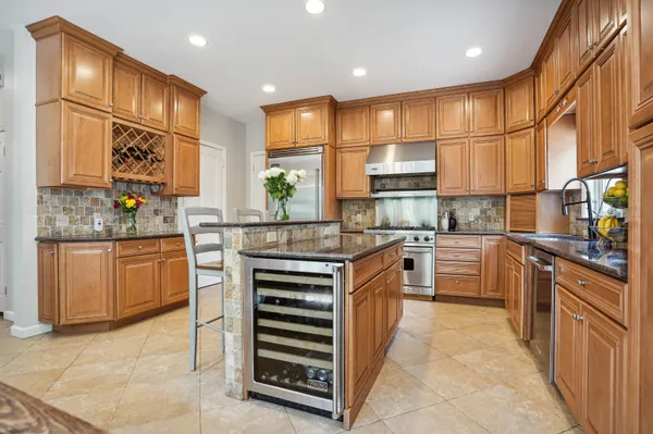 a kitchen with stainless steel appliances a stove sink and cabinets