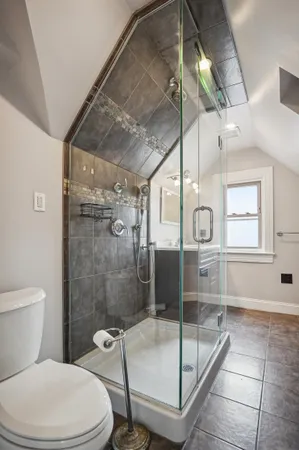 a bathroom with a toilet and a shower