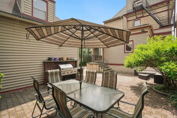 a view of a patio with table and chairs with plants and plants