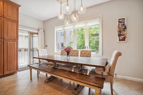 a dining room with furniture a chandelier and window
