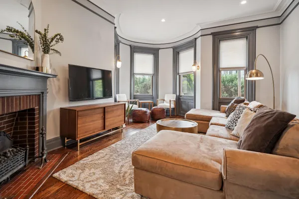 a living room with furniture tv and a fireplace