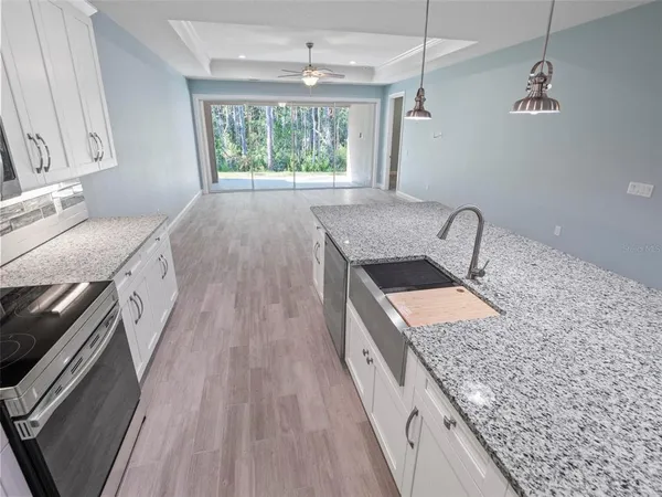 a kitchen with a sink stove and refrigerator