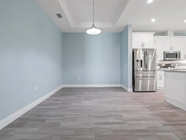 a kitchen with stainless steel appliances a refrigerator and a stove top oven