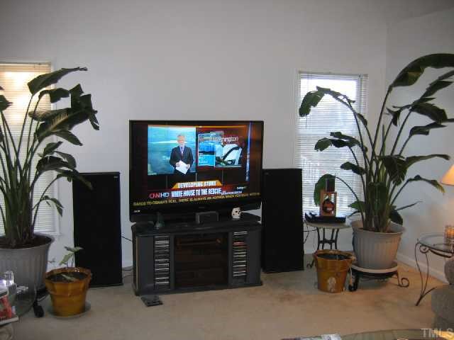 11801 North Exeter Way Raleigh, NC 27613 - Photo 3 of 12 a living room with furniture and a flat screen tv