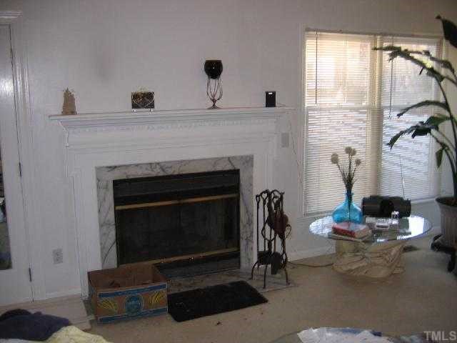 11801 North Exeter Way Raleigh, NC 27613 - Photo 4 of 12 a living room with furniture and a fireplace
