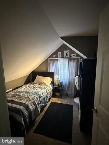 a bedroom with a bed and a mirror