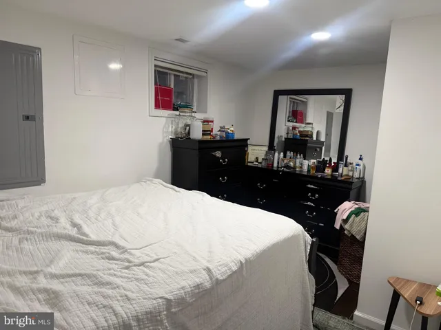 a bedroom with a bed and a dresser