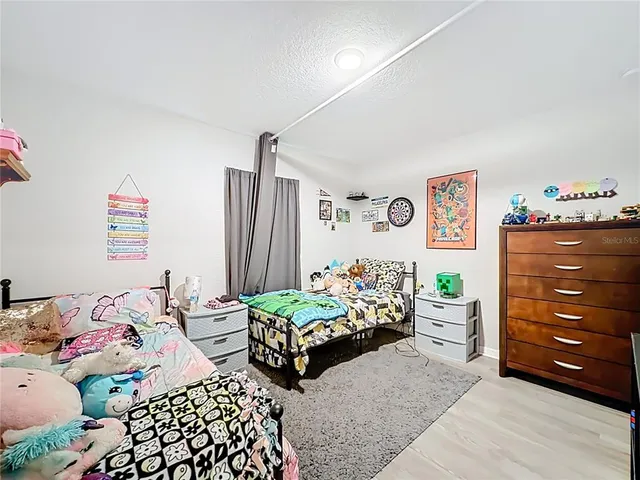 a bedroom with two beds and a dresser