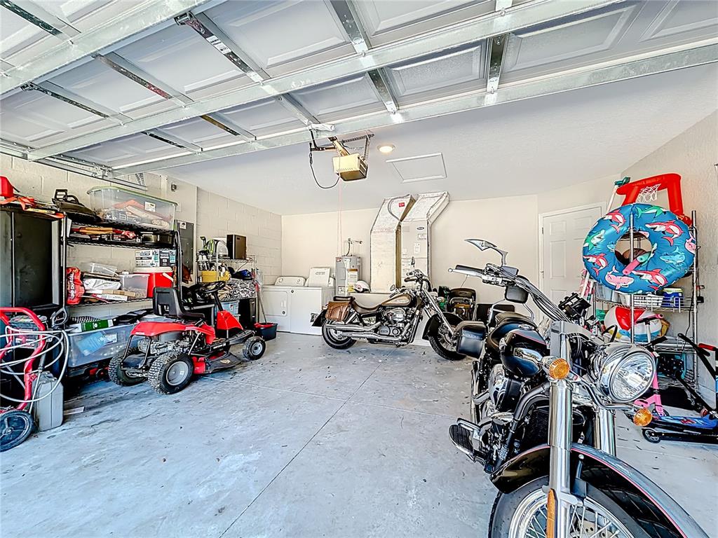 6188 East Seneca Street Inverness, FL 34452 - Photo 27 of 32 a view of a garage with a bike and car