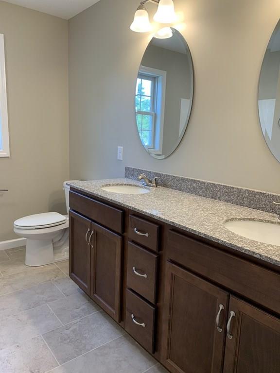 55 Delaware Avenue Springfield, MA 01119 - Photo 12 of 20 a bathroom with a granite countertop toilet a sink and a mirror