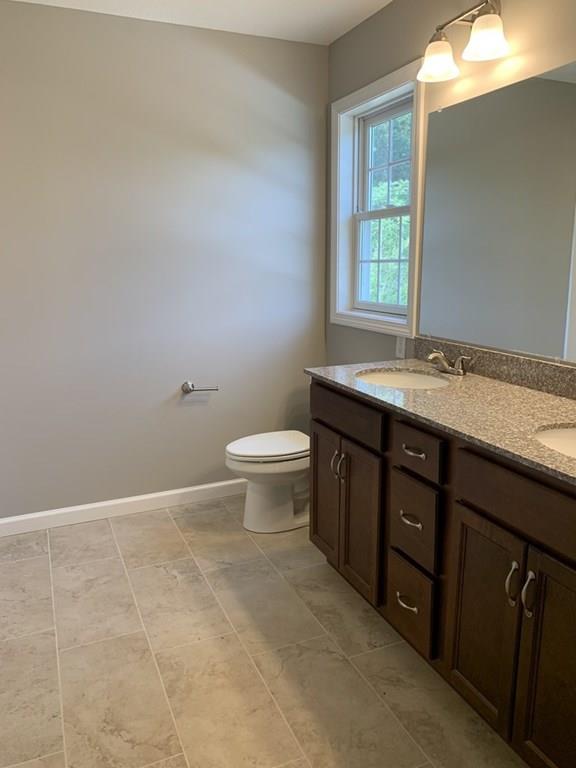 55 Delaware Avenue Springfield, MA 01119 - Photo 18 of 20 a bathroom with a granite countertop sink a toilet and a window