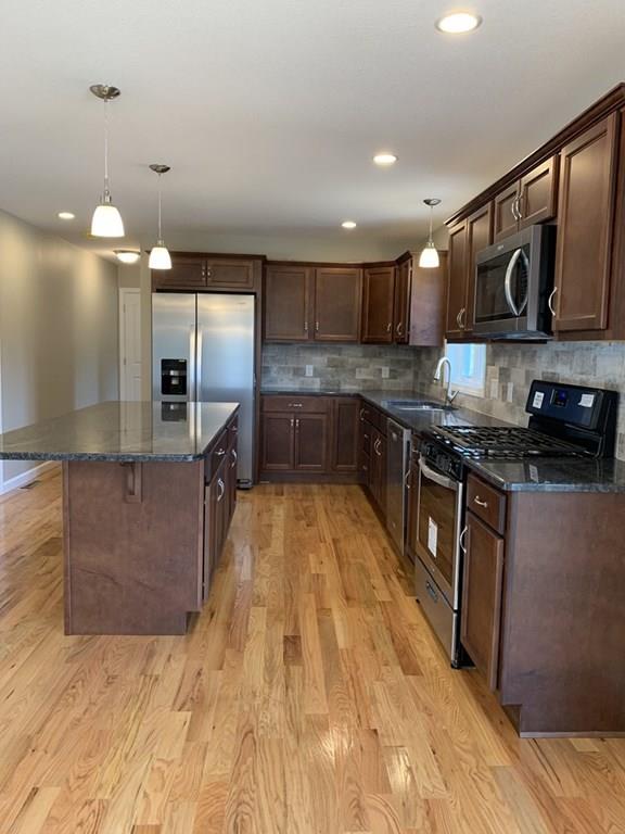55 Delaware Avenue Springfield, MA 01119 - Photo 3 of 20 a large kitchen with stainless steel appliances kitchen island granite countertop a sink and cabinets