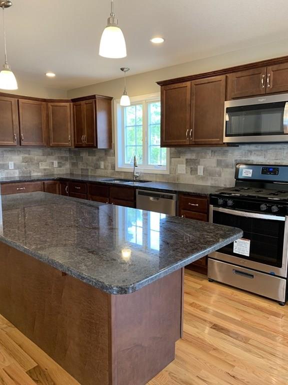 55 Delaware Avenue Springfield, MA 01119 - Photo 4 of 20 a kitchen with stainless steel appliances granite countertop a stove a sink and a microwave