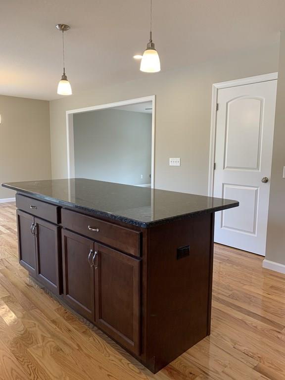 55 Delaware Avenue Springfield, MA 01119 - Photo 5 of 20 a kitchen with kitchen island granite countertop a stove and a sink