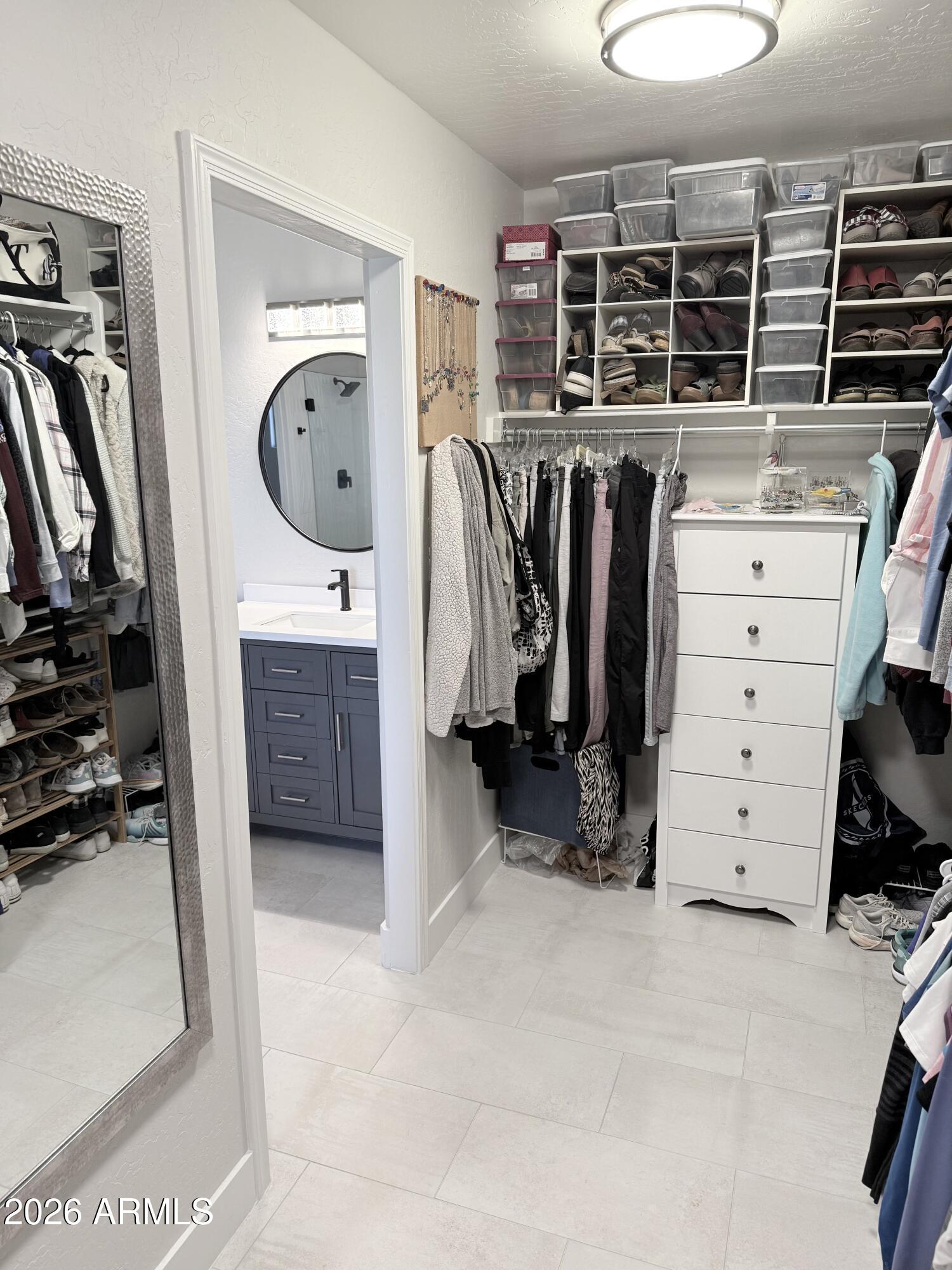 3426 East Clark Road Phoenix, AZ 85050 - Photo 27 of 48 a view of walk in closet with clothes and shoes