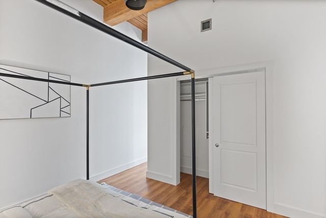 a bedroom with a bed and a mirror