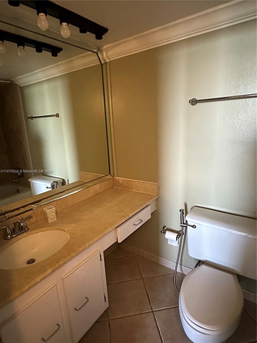 6770 Indian Creek Drive, Unit 11M Miami Beach, FL 33141 - Photo 6 of 10 a bathroom with a sink toilet and shower