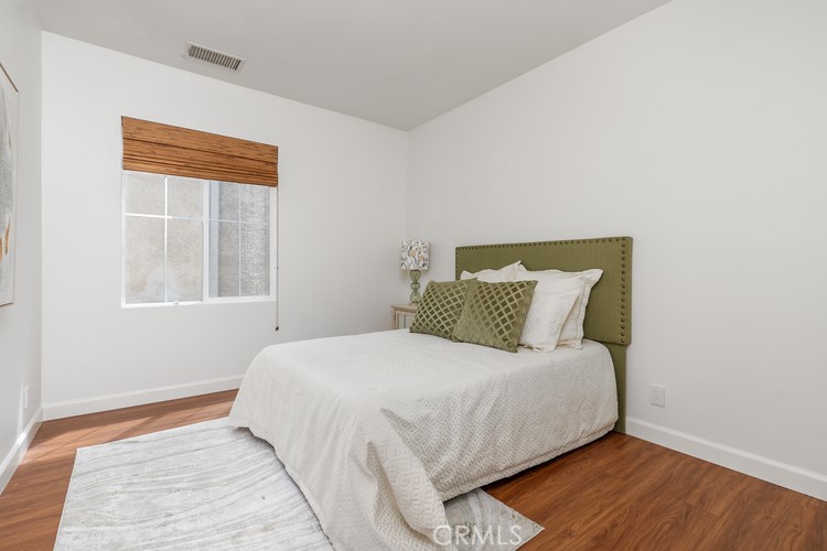 309 Flint Avenue Long Beach, CA 90814 - Photo 26 of 37 a bedroom with a bed and wooden floor