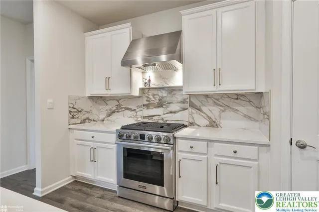 a living room with a fireplace and potted plant