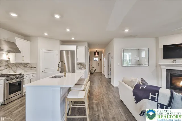 a bedroom with a bed flat screen tv and a window