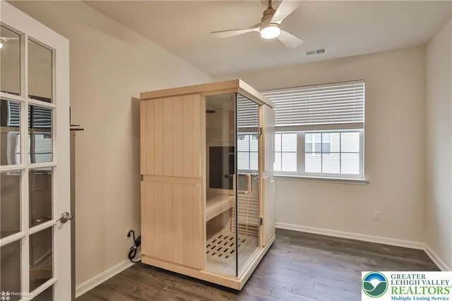 a bathroom with a sink a toilet a mirror and shower