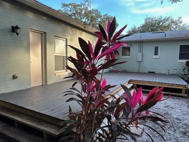 a view of backyard with deck and outdoor seating