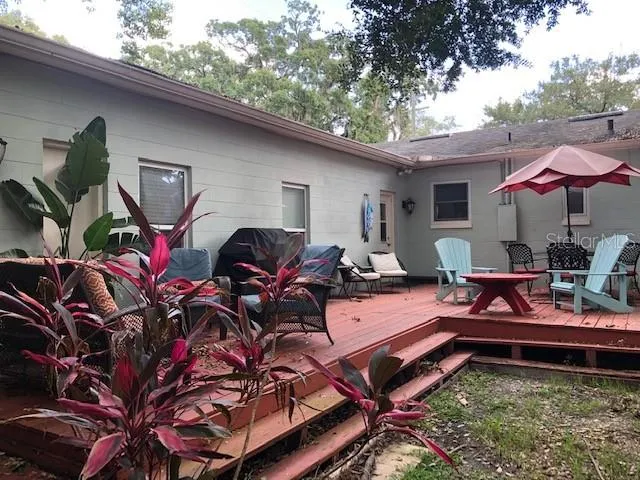 a backyard of a house with barbeque oven table and chairs