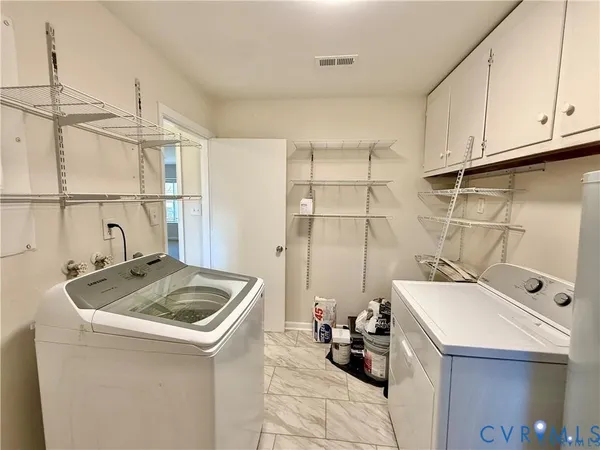 a utility room with sink dryer and washer