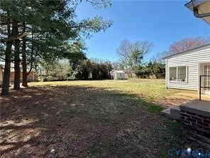 a view of a backyard with large trees