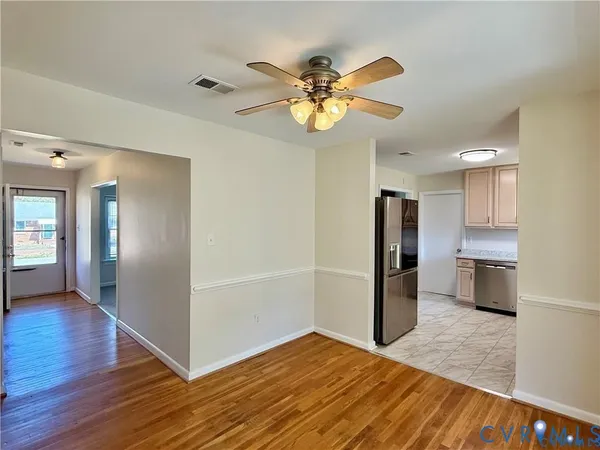a view of a kitchen with wooden floor a sink and dishwasher
