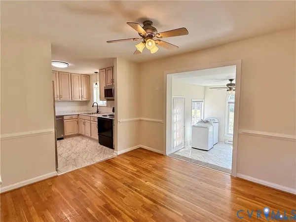 a view of a kitchen with wooden floor and a kitchen