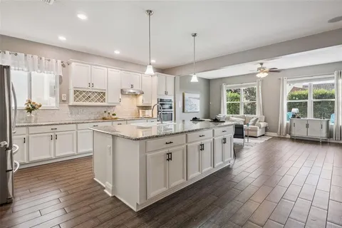 a living room with furniture and kitchen view
