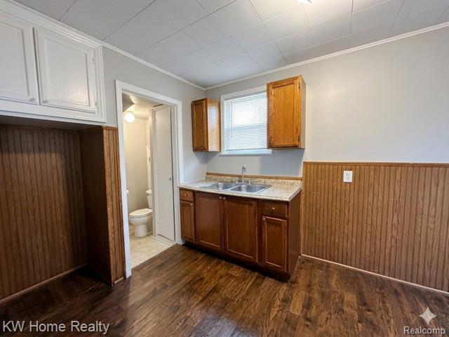 4607 Cadieux Road Detroit, MI 48224 - Photo 3 of 18 Kitchen with wooden walls, light countertops, wainscoting, ornamental molding, and dark wood-style flooring