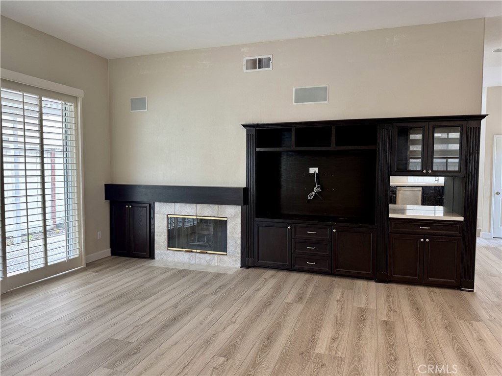 62 Northern Pine Loop Aliso Viejo, CA 92656 - Photo 11 of 27 a living room with a fireplace and a flat screen tv
