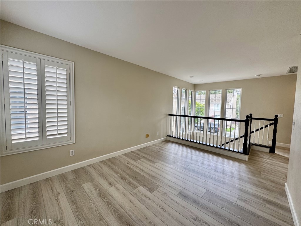 62 Northern Pine Loop Aliso Viejo, CA 92656 - Photo 18 of 27 a view of a room with wooden floor and windows