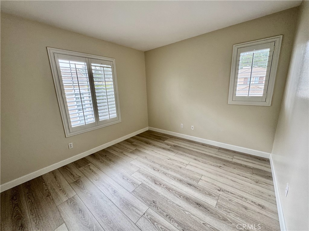 62 Northern Pine Loop Aliso Viejo, CA 92656 - Photo 23 of 27 an empty room with wooden floor and windows