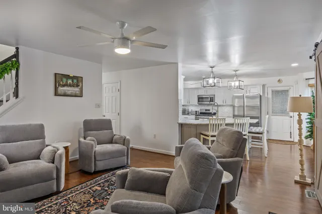 a living room with furniture and kitchen view