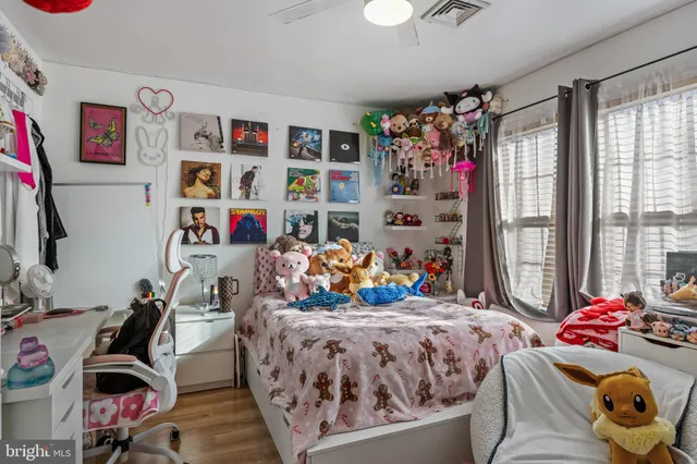 a bed room with a bed a couch and a window